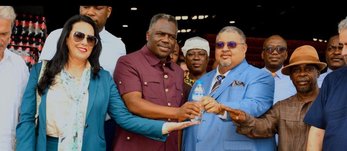 In the center of this group photo, Vice President of Liberia, Honorable Jeremiah Kpan Koung (left), is captured beside Minister Amin Modad (right), during the Aqualife Ribbon-Cutting.